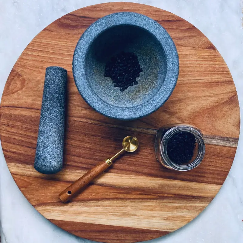 elderberries in mortar and pestle for cold and flu remedy