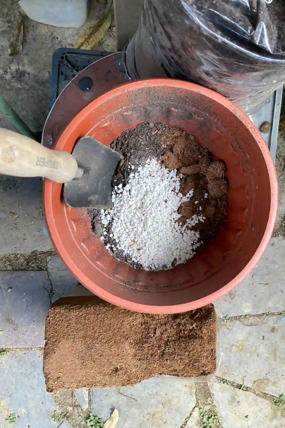 essential gardening tools (1) top view of soil in a pot with perlite , coco coir and potting mix